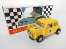 Scalextric - A vintage 1970s C-7 Mini Cooper in yellow in a reproduction box.