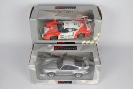 UT Models - 2 x boxed 1:18 scale Porsche models,