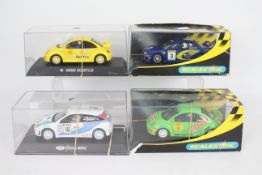 Scalextric - 4 x boxed cars, two VW Beetle Cup cars, a Ford Focus WRC and a Subaru Impreza WRC.