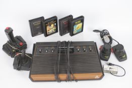 Atari - A vintage Atari CX-2600 U console with wood grain finish, it comes with a joy stick,