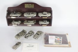 Danbury Mint - A boxed collection of 10 Danbury Mint Jaguar 1:43 scale pewter cars with wooden