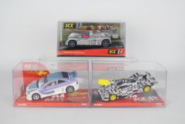 SCX - Three boxed SCX 1:32 scale slot cars.