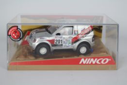 Ninco - A boxed Mitsubishi Pajero Rally car in silver # 50314.