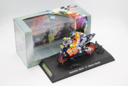 Scalextric - A boxed 2004 Moto GP Repsol Honda ridden by Valentino Rossi # C6000 The model appears