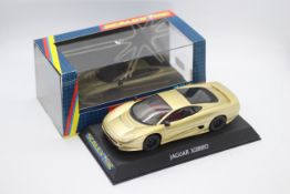 Scalextric - A boxed Jaguar XJ220 in gold with working lights # C2083.