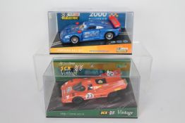 Scalextric - SCX - 2 x boxed Porsche models,