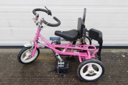 Theraplay - A pink IMP disability tricycle.
