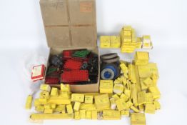 Meccano - A quantity of boxed and loose Meccano parts including 85 x yellow boxes with unused spare