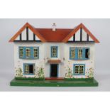 Triang - A wooden Dolls House possibly by Triang together with contents .