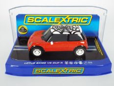 Scalextric - A boxed Scalextric Mini Cooper in red with web roof,