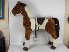 Costco - An unboxed Costco Sit-On Plush toy horse.