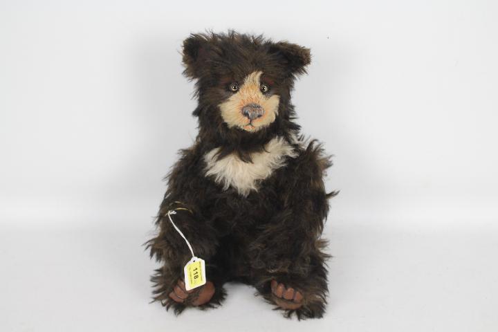 Unnamed - A vintage Grizzly Bear with jointed limbs and a stitched nose.