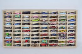 Hot Wheels - A wooden display cabinet containing 80 x loose Hot Wheels cars including Subaru