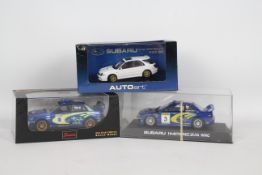 Scalextric - Saico - Autoart - 3 x boxed Subaru Impreza models including a 1:32 scale 1999 WRC slot