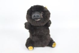 Unnamed - A small jointed Brown Bear with soft plush fur and a hard nose and muzzle.