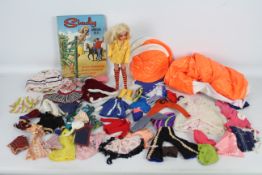 Sindy - A vintage Sindy doll with a large quantity of clothing and some accessories.