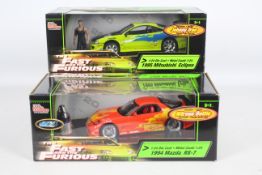 Racing Champions / Ertl - Two boxed 1:24 scale 'Fast & Furious' diecast model cars.