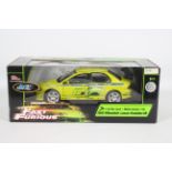 Racing Champions / Ertl - A boxed 1:18 scale 'Fast & Furious' diecast 2002 Mitsubishi Lancer