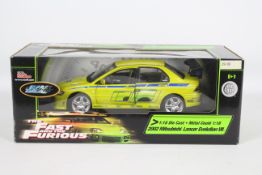Racing Champions / Ertl - A boxed 1:18 scale 'Fast & Furious' diecast 2002 Mitsubishi Lancer