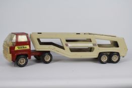 Tonka - A large vintage pressed steel Tonka car transporter which measure 69 cm in length.