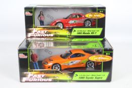 Racing Champions / Ertl - Two boxed 1:24 scale 'Fast & Furious' diecast model cars.