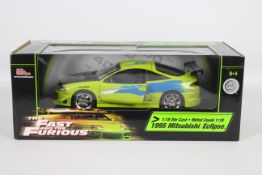 Racing Champions / Ertl - A boxed 1:18 scale 'Fast & Furious' diecast 1995 Mitsubishi Eclipse.