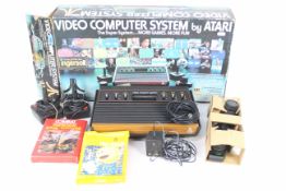 Atari - A boxed vintage Atari CX-2600 U Woodgrain computer system with its power lead and two