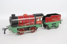 Hornby - A 1930s clockwork 0-4-0 tender loco number 3435 in red and green livery.