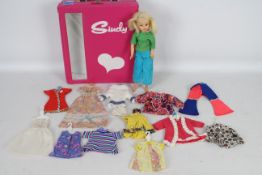 Sindy - A vintage Sindy carry case with doll and 12 x clothes hangers with outfits.