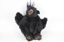 A 2008 Citigo Ridge 'One Of a Kind' black toy bear with wings and a black, plastic crown.