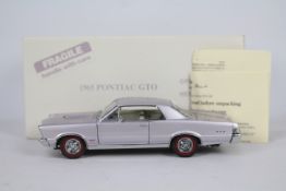 Danbury Mint - A boxed 1:24 scale diecast 1965 Pontiac GTO by Danbury Mint.