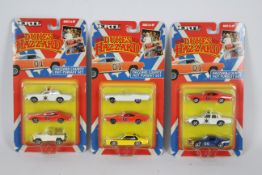 Ertl - Three carded 1:64 scale '#7068 'The Dukes of Hazzard - Hazzard County Hot Pursuit Sets'.