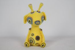 Unknown Maker - A yellow-coloured animal with glass eyes.