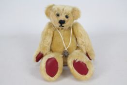 Waverley Paige - A small fully jointed long limbed bear with red leather pads and the makers label