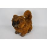 Unknown Maker - A poseable Pomeranian dog soft toy with long plush orange and brown fur.