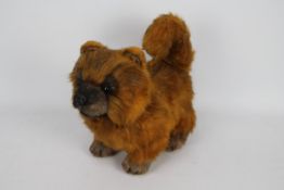 Unknown Maker - A poseable Pomeranian dog soft toy with long plush orange and brown fur.