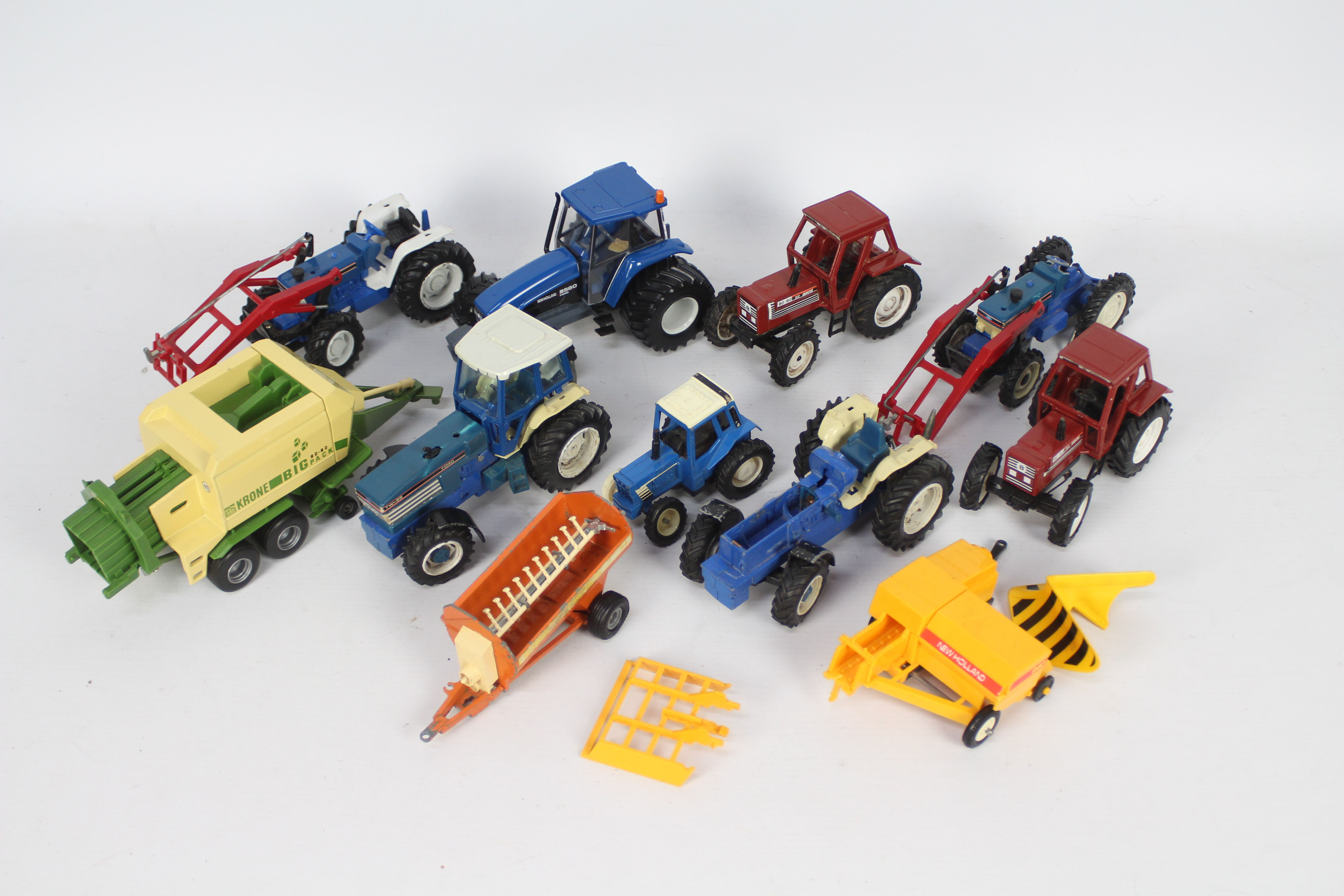 Britains, Others - A collection of 11 unboxed diecast and plastic farm vehicles and implements,