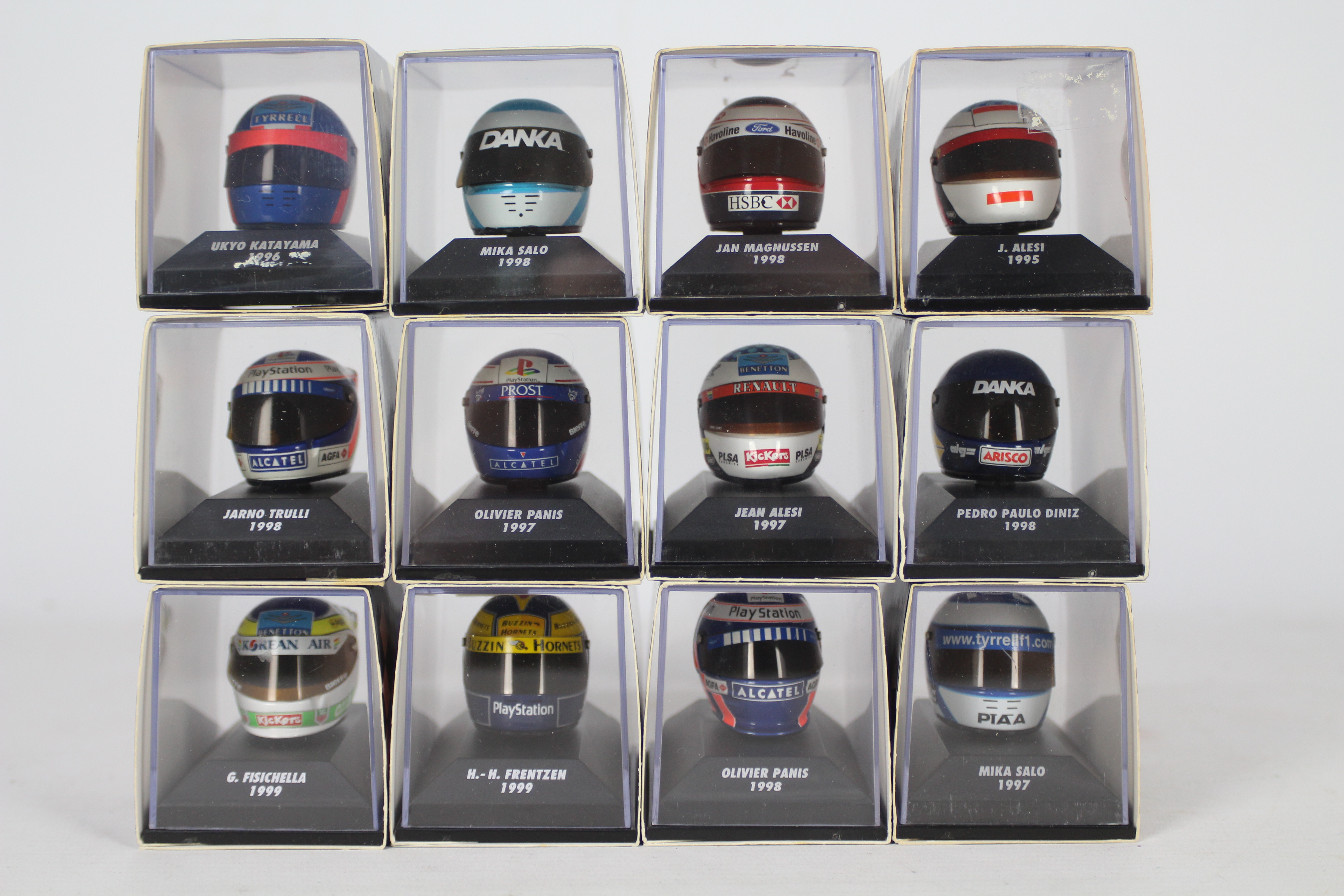 Minichamps - A starting grid of 12 boxed 1:8 scale F1 racing drivers helmets by Minichamps.