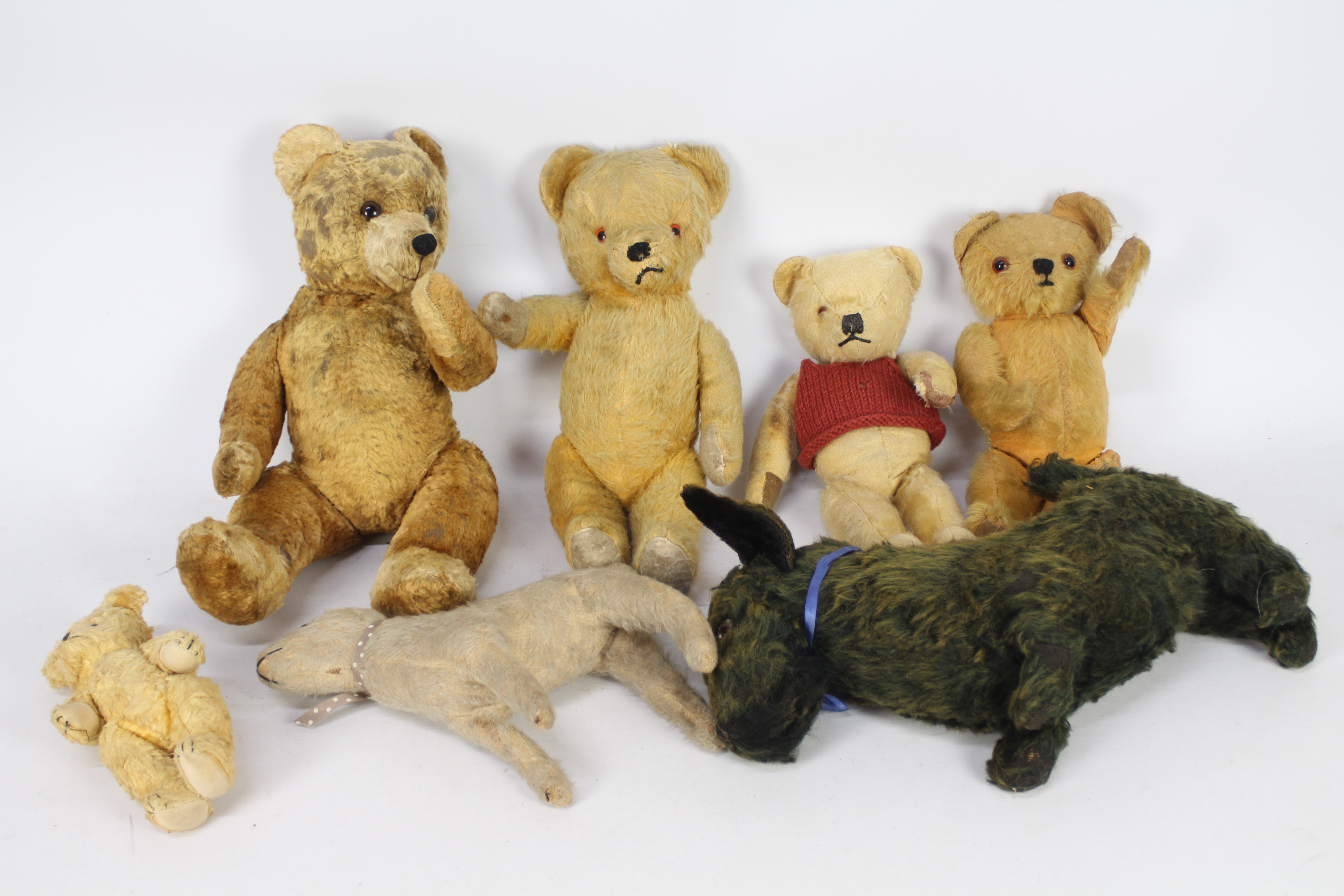 A collection of vintage unmarked teddy bears.