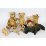 A collection of vintage unmarked teddy bears.