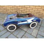 Torng Woei - A vintage blue metal pedal car with lots of patina.