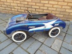 Torng Woei - A vintage blue metal pedal car with lots of patina.