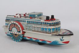 Modern Toys - An unboxed vintage tinplate battery powered Queen River boat.