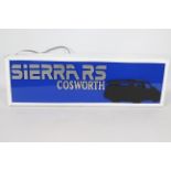 A Sierra RS Cosworth illuminated lightbox sign, approximately 21 cm x 67 cm.
