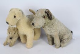 Three vintage terrier type soft toy dogs.