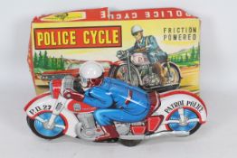 Haji - A boxed vintage Haji tinplate friction powered Police Motorcycle # 2799.
