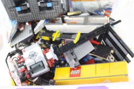 Lego - A large tub of loose Lego pieces and part built vehicles.