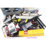 Lego - A large tub of loose Lego pieces and part built vehicles.