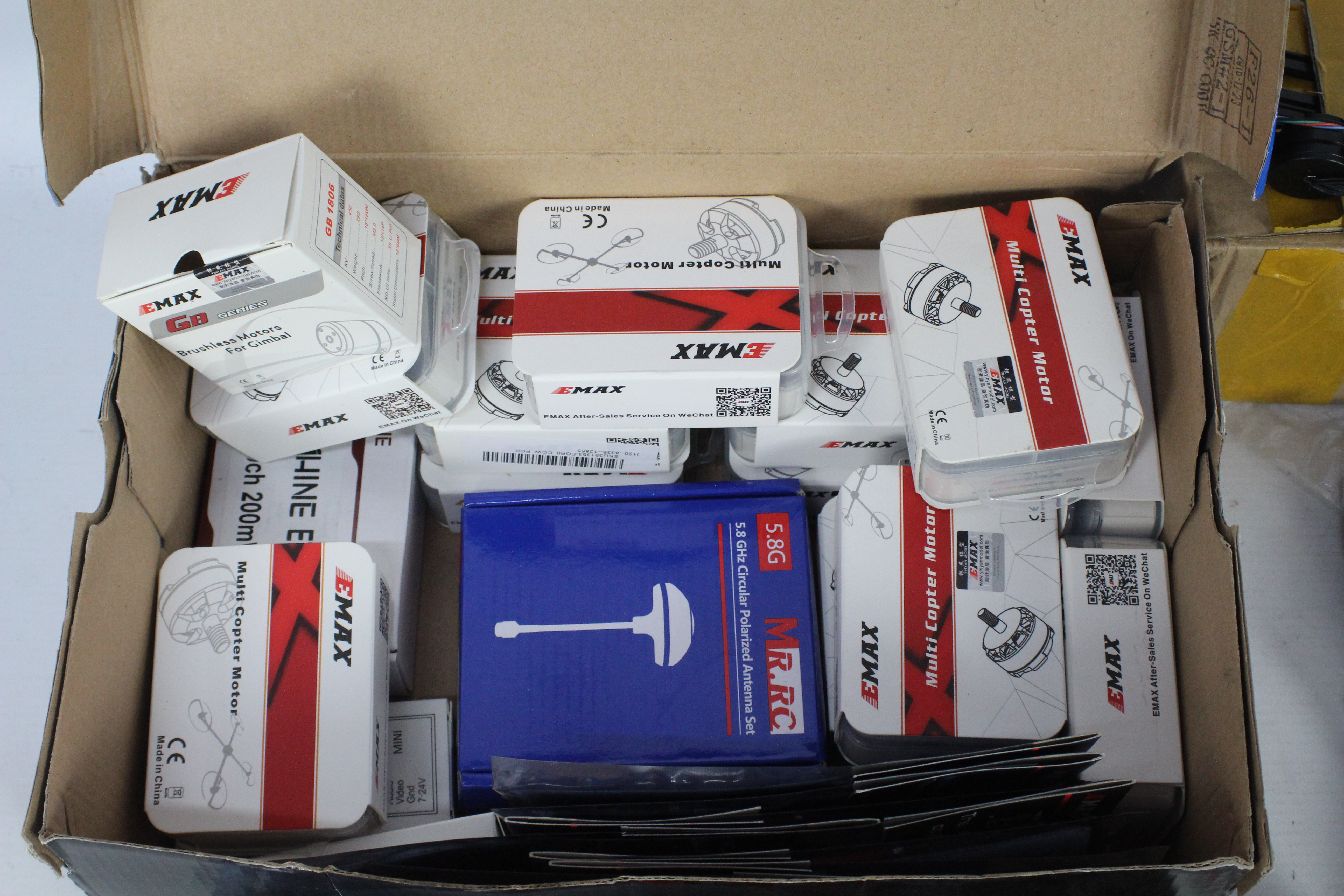 A collection of R/C spare parts and a carbon fibre quad copter frame with a box of brushless motors. - Image 3 of 5