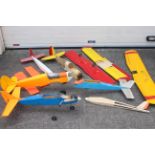 A mixed lot of scratch built remote control airplanes and parts and control surfaces with one